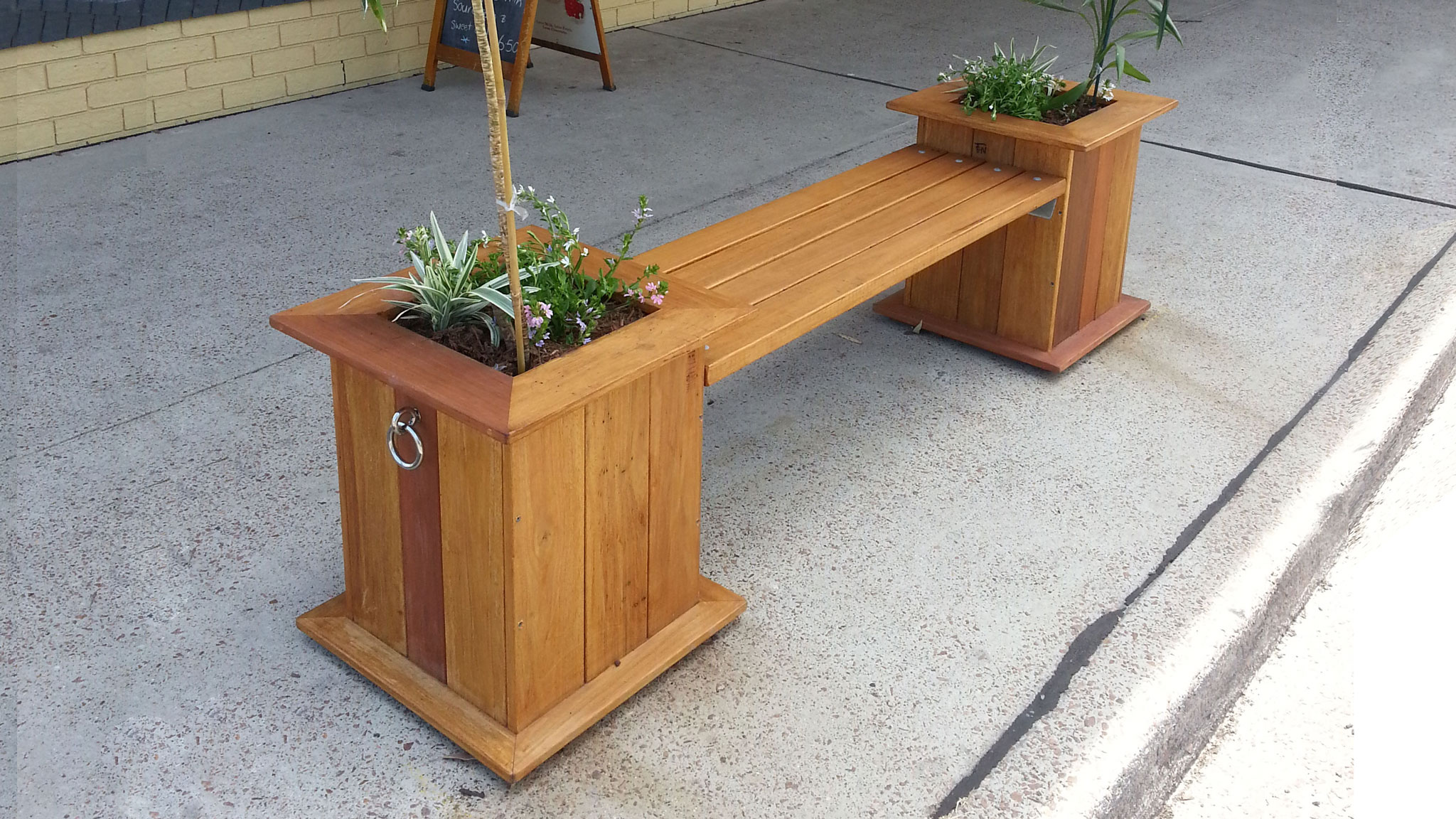Photo showing a planter box bench built by the shed