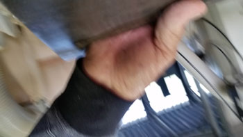 An upside-down blurry photo of part of the photographer's hand and arm